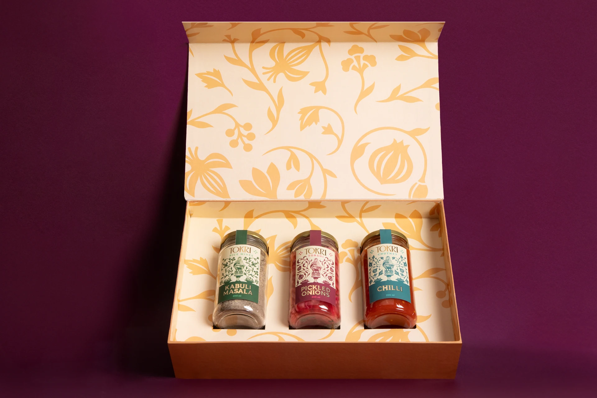 Tokri gift box with three jars on burgundy